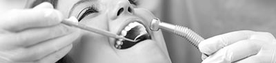 Woman in dentist chair. Dental examination preformed by dentist.